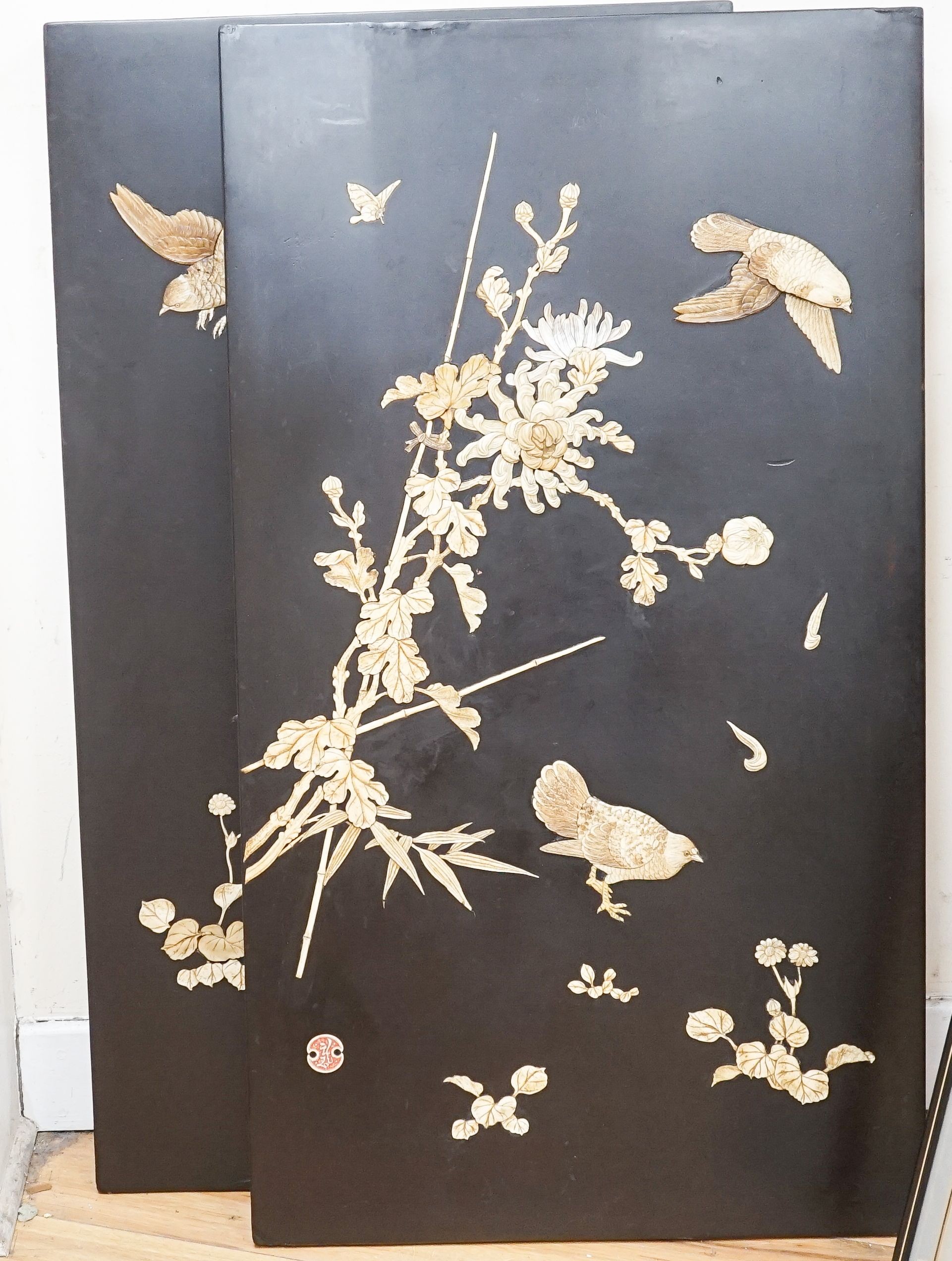 A pair of late 19th century Japanese bone and mother of pearl inlaid shibayama style panels of birds amid flowers, 91 x 51cm